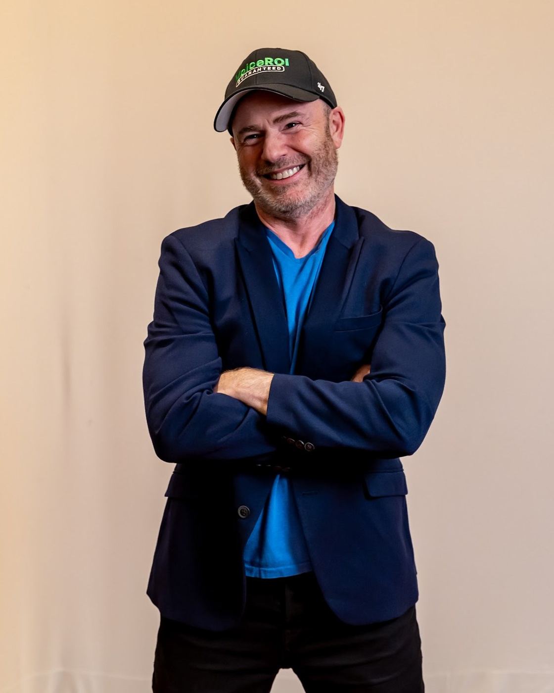Mike Weiss in a VoiceROI cap, arms crossed, smiling